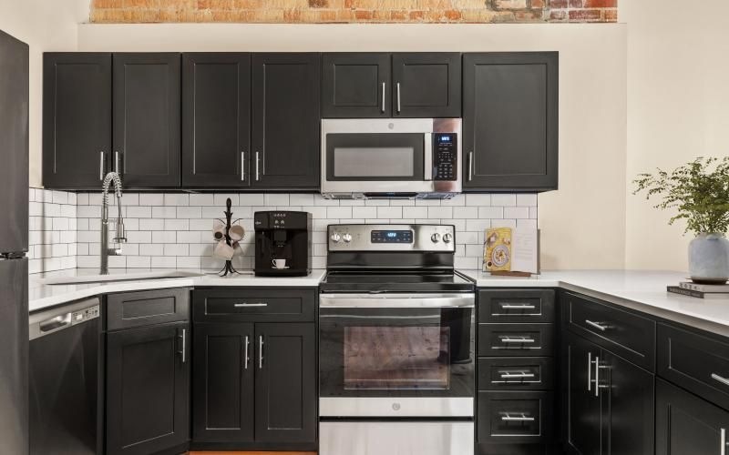 a kitchen with black cabinets