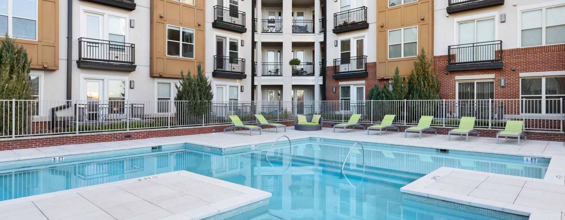 a swimming pool in a courtyard between buildings