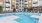 a swimming pool in a courtyard between buildings