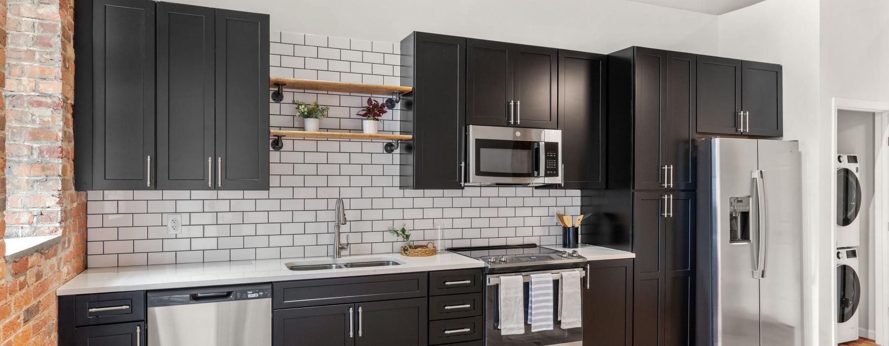 a kitchen with black cabinets