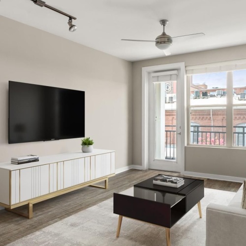 Generous living spaces with beautiful natural lighting a living room with a tv and couches