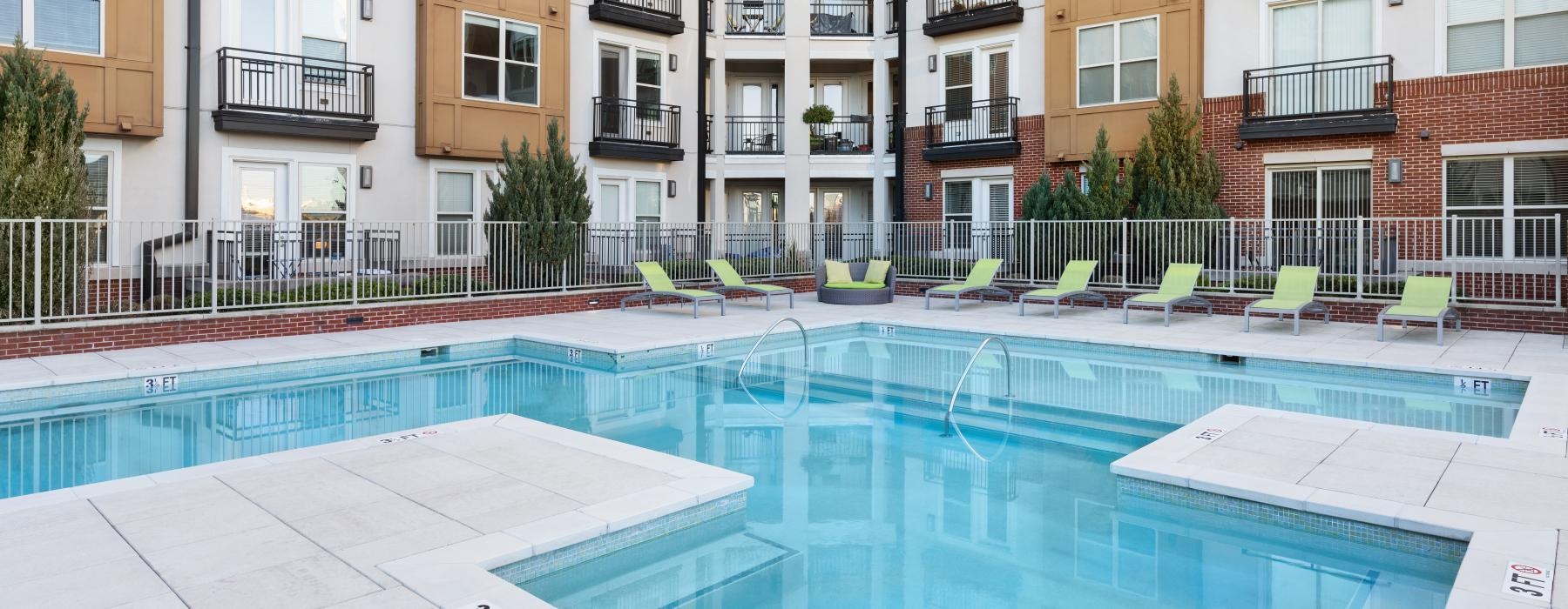 a swimming pool in a courtyard between buildings