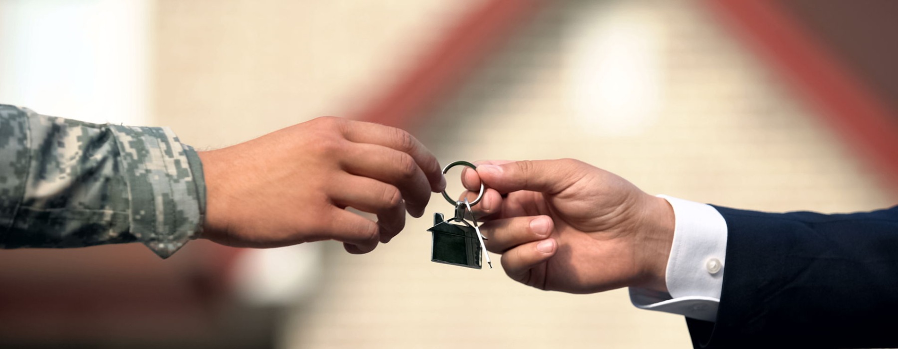 person handing keys over to another person