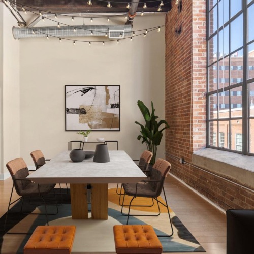 Generous living spaces with beautiful natural lighting a room with a table chairs and a window